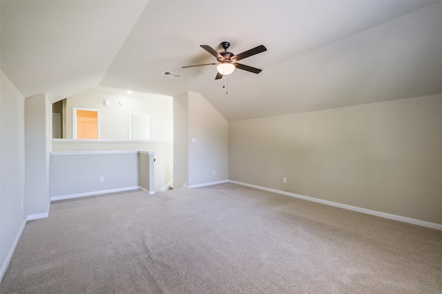 bonus room with light colored carpet, vaulted ceiling, and ceiling fan