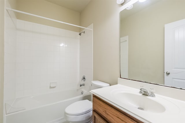 full bathroom with vanity, tiled shower / bath combo, and toilet