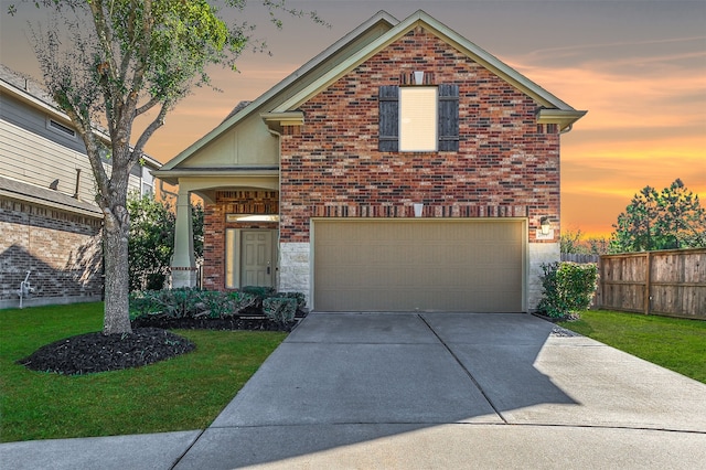 front facade featuring a yard and a garage