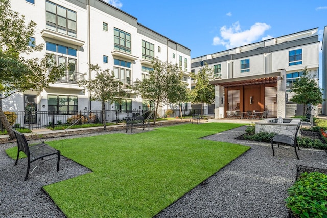 view of property's community with a pergola, a yard, and a patio area