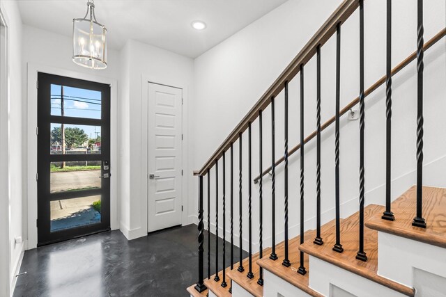 foyer entrance featuring an inviting chandelier