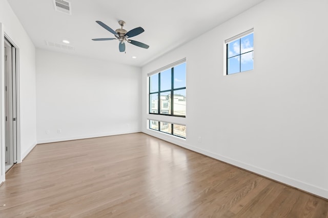 spare room with light wood-type flooring and ceiling fan