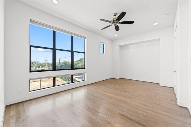 empty room with light hardwood / wood-style floors and ceiling fan