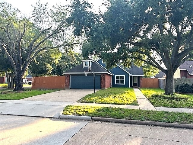 ranch-style house featuring a front yard and a garage