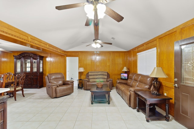 living room featuring wood walls, ceiling fan, and lofted ceiling