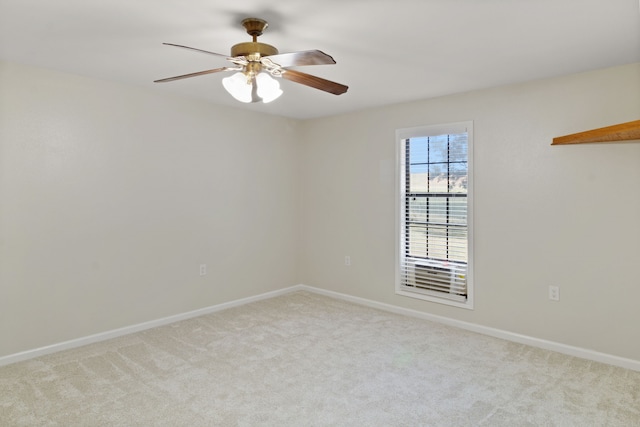 spare room featuring ceiling fan and light colored carpet