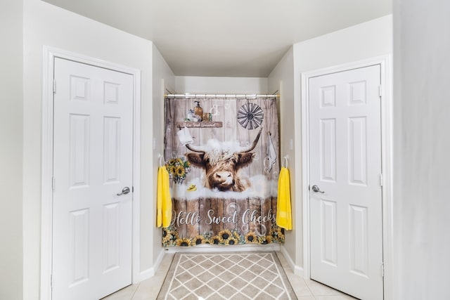 bathroom with tile patterned flooring and curtained shower