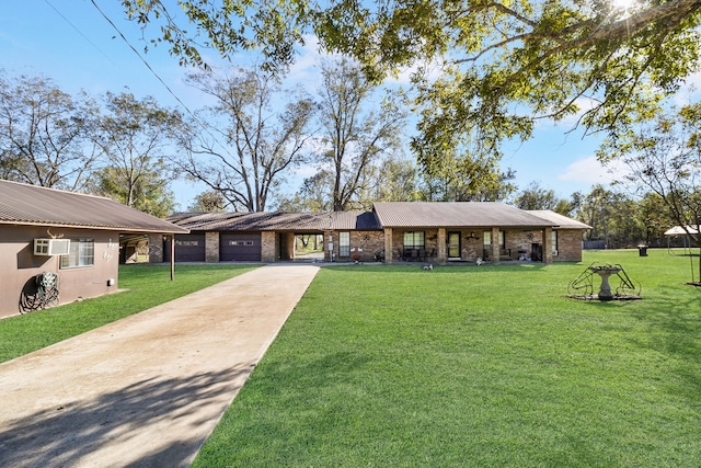 ranch-style house featuring a front yard and a garage