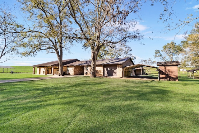 exterior space featuring a yard and a carport