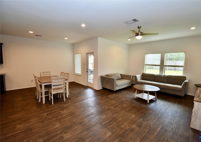 living room with dark wood-type flooring and ceiling fan