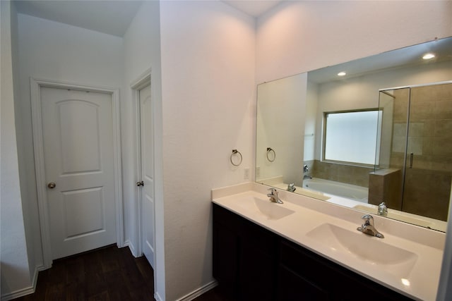 bathroom with shower with separate bathtub, vanity, and hardwood / wood-style floors