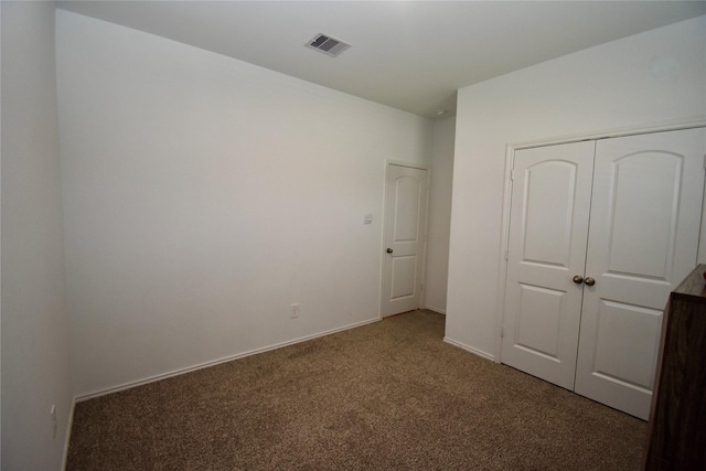 unfurnished bedroom with a closet and carpet