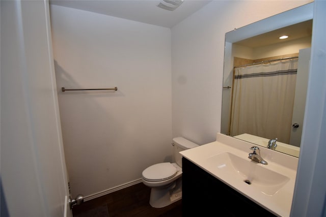 bathroom featuring hardwood / wood-style flooring, curtained shower, vanity, and toilet