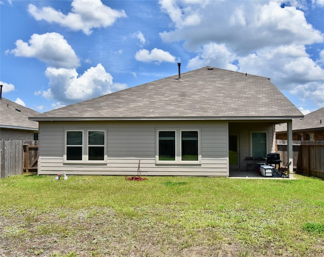 back of house featuring a patio area and a lawn