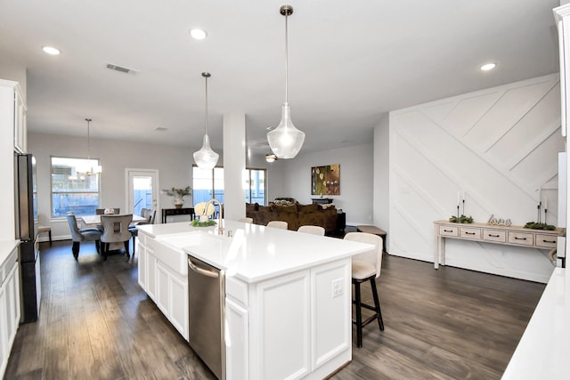 kitchen featuring a center island with sink, white cabinets, sink, dark hardwood / wood-style flooring, and stainless steel appliances