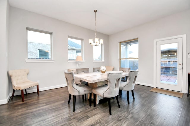 dining room featuring a wealth of natural light, dark hardwood / wood-style flooring, and a chandelier