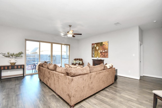 living room featuring ceiling fan and wood-type flooring