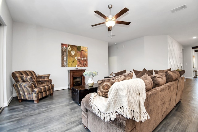 living room featuring dark hardwood / wood-style flooring and ceiling fan