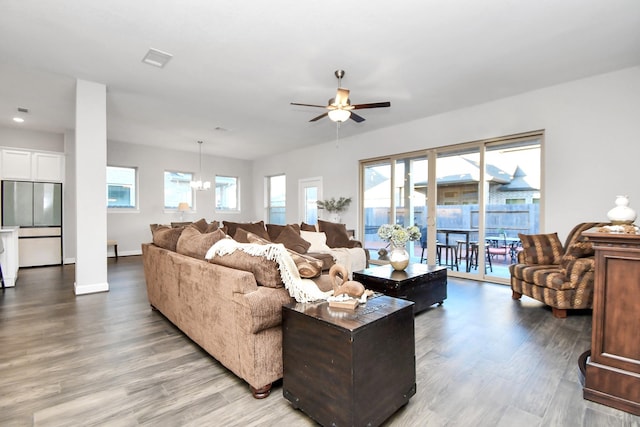 living room featuring wood-type flooring and ceiling fan with notable chandelier