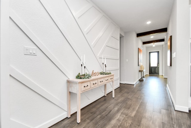 hallway featuring beam ceiling and dark hardwood / wood-style flooring