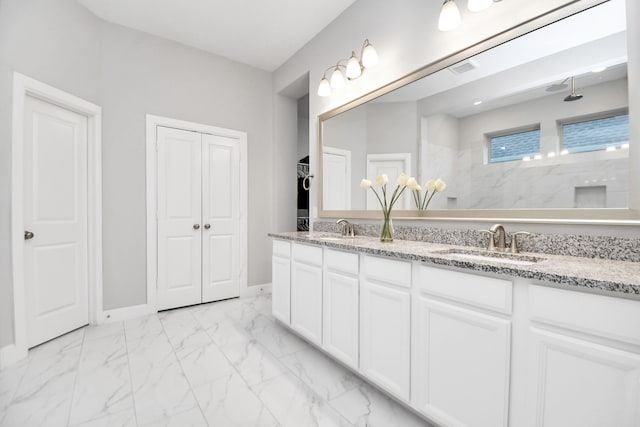 bathroom featuring a shower and vanity