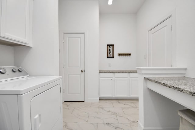 washroom with cabinets and washing machine and dryer