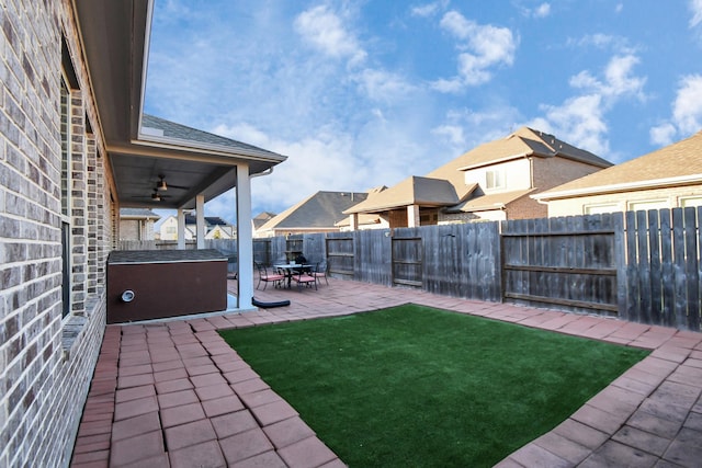 view of yard with ceiling fan and a patio