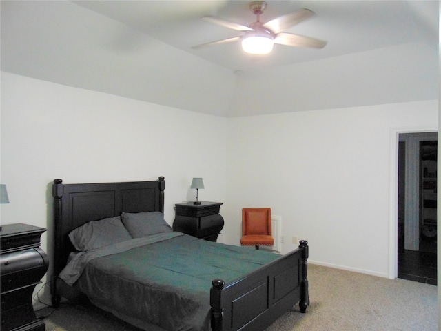 bedroom featuring light colored carpet, vaulted ceiling, and ceiling fan