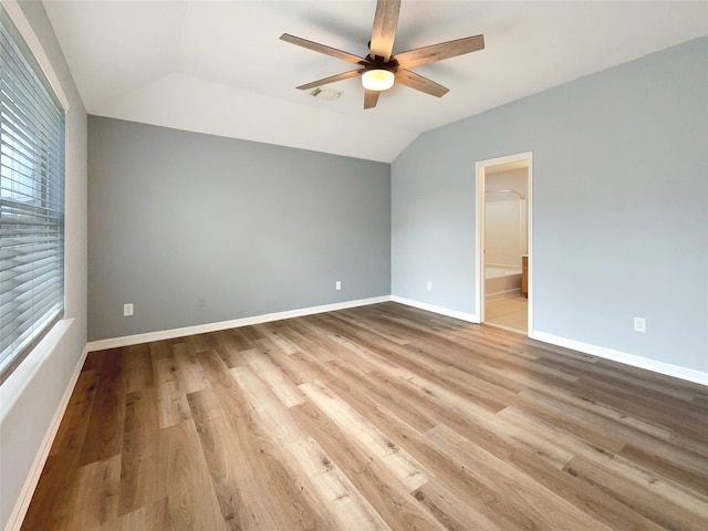 spare room with ceiling fan, light hardwood / wood-style flooring, and lofted ceiling