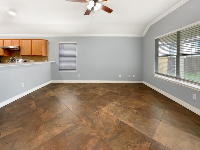 spare room with ceiling fan, sink, crown molding, and vaulted ceiling