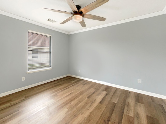 spare room featuring ceiling fan, hardwood / wood-style floors, and ornamental molding