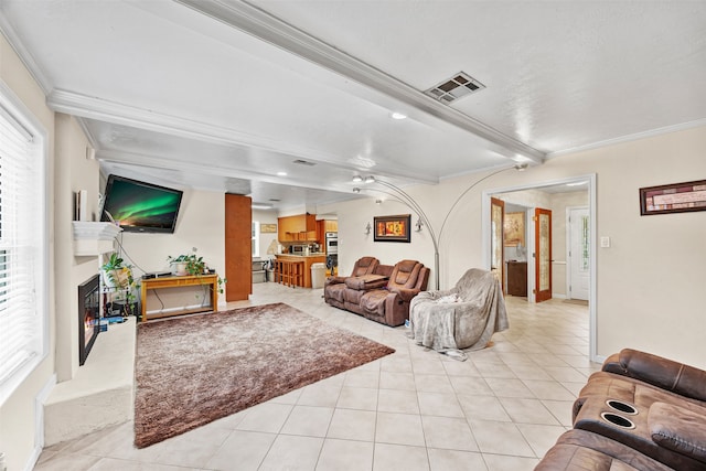 living room with beamed ceiling, light tile patterned floors, and ornamental molding