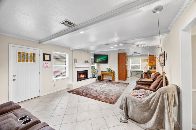 living room featuring crown molding, beamed ceiling, light tile patterned floors, and a textured ceiling