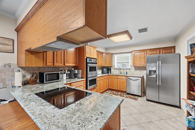 kitchen with sink, stainless steel appliances, light stone counters, kitchen peninsula, and ornamental molding