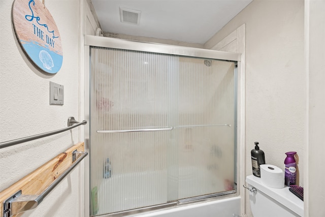 bathroom with toilet and enclosed tub / shower combo