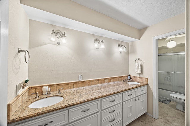 full bathroom featuring tile patterned floors, a textured ceiling, vanity, shower / bath combination with glass door, and toilet