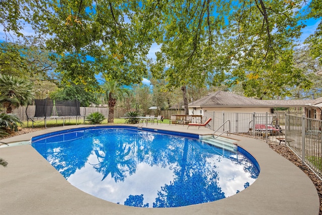 view of pool featuring a patio area and a trampoline