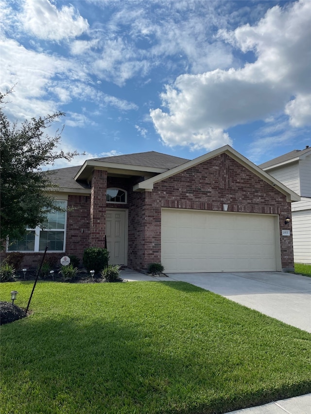 ranch-style home with a garage and a front lawn