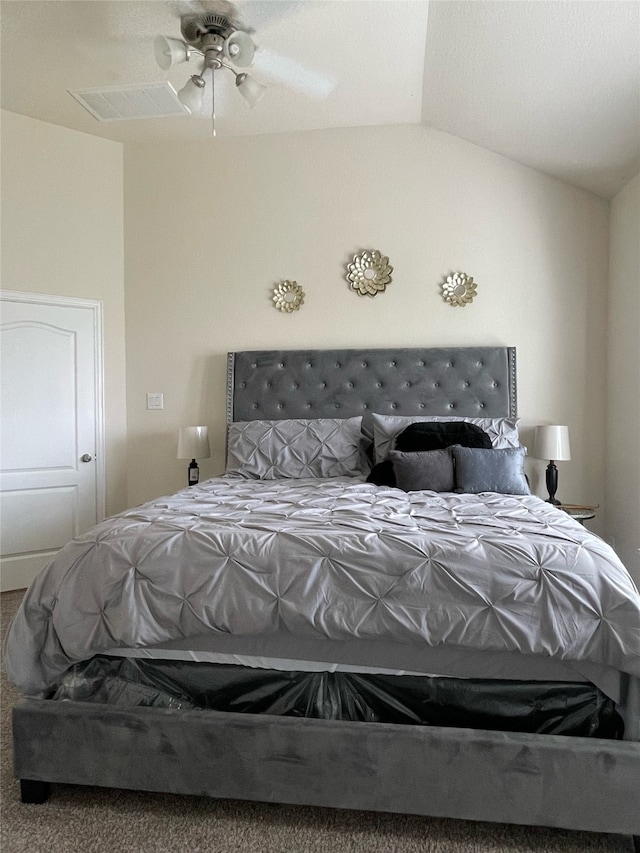 bedroom featuring carpet flooring, vaulted ceiling, and ceiling fan