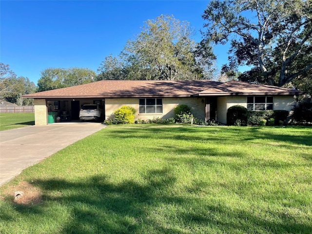 ranch-style home featuring a front lawn and a carport