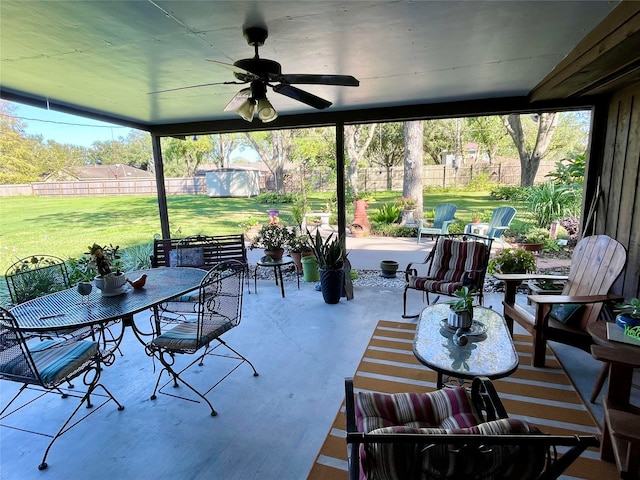 view of patio with ceiling fan and a storage shed