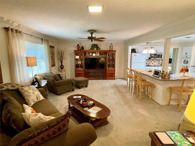 carpeted living room with a textured ceiling, ceiling fan, and crown molding