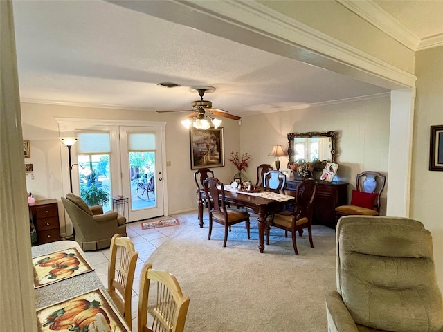 tiled dining area featuring a textured ceiling, ceiling fan, and crown molding