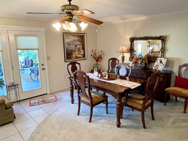 dining space featuring ceiling fan, crown molding, and light tile patterned flooring