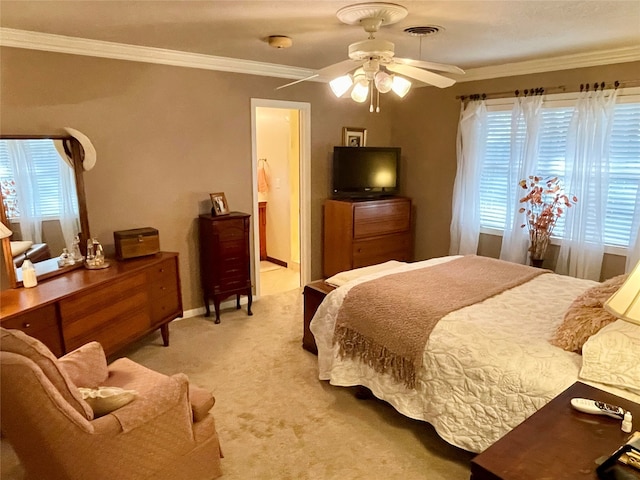 carpeted bedroom with multiple windows, ensuite bath, ceiling fan, and ornamental molding