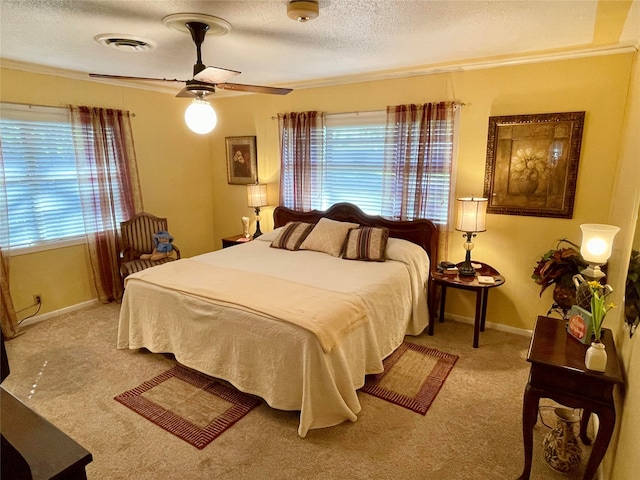 carpeted bedroom featuring a textured ceiling, ceiling fan, and crown molding