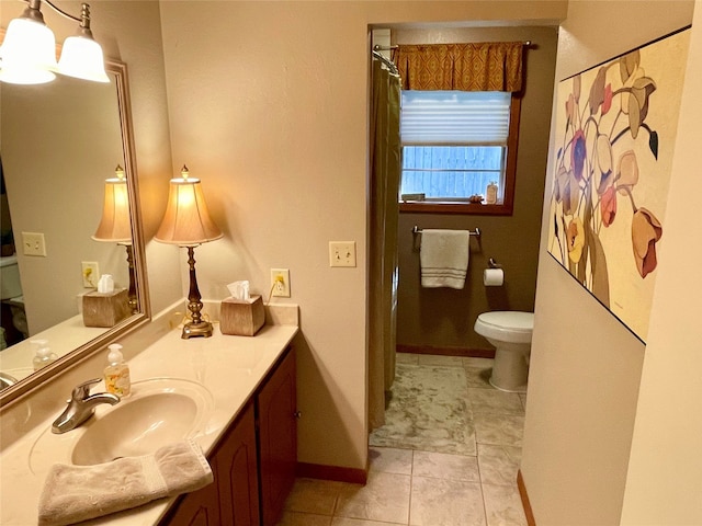 bathroom featuring tile patterned floors, vanity, and toilet