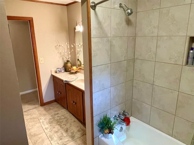 bathroom featuring tile patterned floors, vanity, and tiled shower / bath