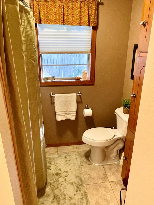 bathroom with tile patterned floors and toilet