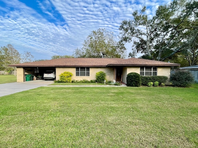 ranch-style house featuring a front lawn and a carport